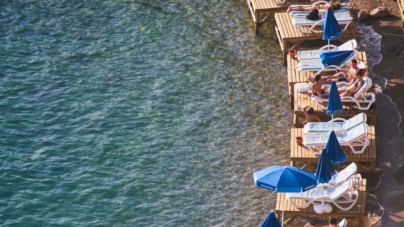 Relaxing on wooden platforms by the beach in Antalya, Turkey.